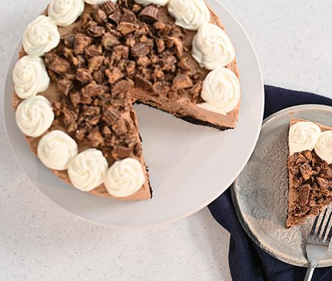 Reese's Peanut Butter Cup Cheesecake with whipped cream