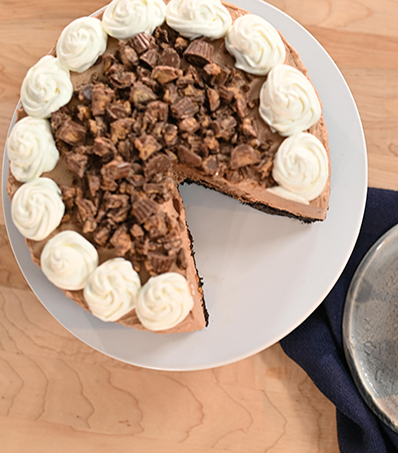No Bake Reese's Peanut Butter Cup Cheesecake with whipped cream