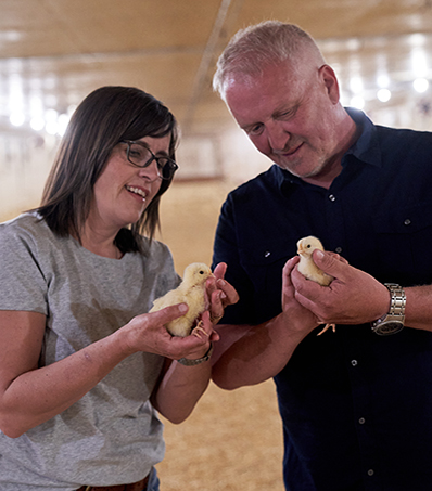 Evy and Rod Wiebe Holding Chicks