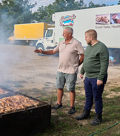 Great Tastes host, George Hudson meets Manitoba chicken farmer, Curtis at the Hanover Ag Society Fair for the the World Famous Chicken BBQ.